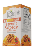 A box of Good Earth California 1973 'New Bolder Flavor Sweet & Spicy' caffeine-free herbal tea, featuring orange and white packaging with illustrations of cinnamon sticks and citrus slices.