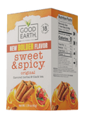 A box of Good Earth Sweet & Spicy Original flavored herbal and black tea, featuring orange and white packaging with illustrations of cinnamon and citrus slices.